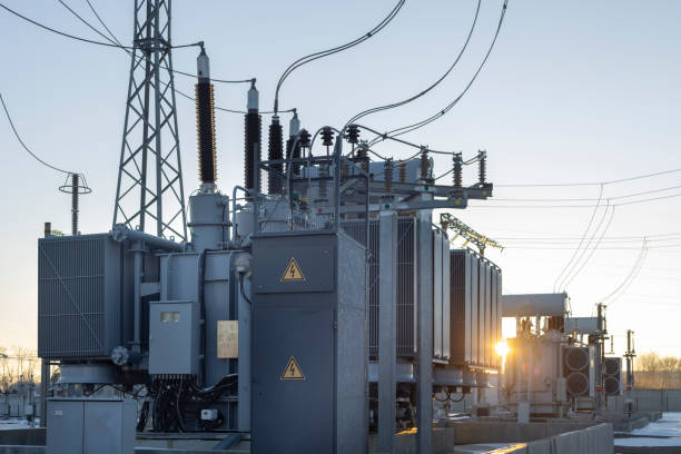 10001 High-voltage transformer substation in winter at dawn. High voltage equipment. Energy transfer technology.